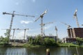 BERLIN, GERMANY, MAY 24, 2018: Many operating cranes at building site in Berlin, beside a canal. Royalty Free Stock Photo