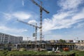 BERLIN, GERMANY, MAY 24, 2018: Many operating cranes at building site in Berlin, beside a canal. Royalty Free Stock Photo