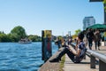 Young man drinks beer at riverside at river Spree, Berlin Wall Royalty Free Stock Photo