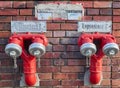 Berlin, Germany - November 29, 2018: red double watery on a brick wall