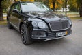 BERLIN, GERMANY - OCTOBER 2020: Bentley Bentayga Hybrid SUV luxury car three fourth right side view outdoors parked on