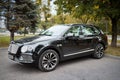 BERLIN, GERMANY - OCTOBER 2020: Bentley Bentayga Hybrid SUV luxury car three fourth view outdoors parked on streets of