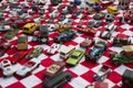 Colorful small toy cars placed on red and white fabric in Flohmarkt im Mauerpark market in Berlin Royalty Free Stock Photo