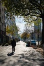 Man walking on the sidewalk in Berlin, Germany in autumn.