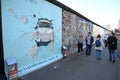 Berlin, Germany - October 31, 2022: People near the Berlin wall in East Side Gallery famous memorial with many grafitti