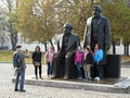 People take pictures near the statue of Karl Marx and Friedrich Engels in Berlin. Royalty Free Stock Photo