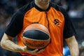 A referee holds the official basket game ball during a EuroLeague match