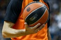 A referee holds the official basket game ball during a Turkish Airlines EuroLeague match Royalty Free Stock Photo