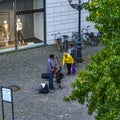 Street musician in the inner city of Berlin, Germany, getting money from a listener who lays it in his guitar case Royalty Free Stock Photo