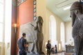 BERLIN, GERMANY - SEPTEMBER 26, 2018: Bright picture of visitors looking at statue exhibitions of Lamassu, an Assyrian