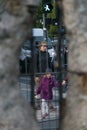 BERLIN, GERMANY - SEPTEMBER 26, 2018: Contrasting and curious perspective through a hole of the Berlin Wall of a child