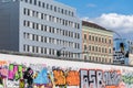 BERLIN, GERMANY - September 26, 2018: Scenic view of a person sitting in front of the colorful graffitis at the Berlin