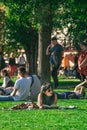 BERLIN, GERMANY - SEPTEMBER 26, 2018: Vertical view of a woman with sunglasses laying in grass reading at the James Royalty Free Stock Photo