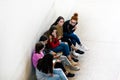 BERLIN, GERMANY - SEPTEMBER 26, 2018: Zoomed in, downwards perspective of a group of girls playing on their smartphones