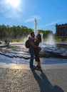 Berlin, Germany, 19th May 2018 An amorous couple represents a large fountain lit by the late afternoon sun