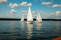 Berlin,Germany, 03.08.2019 .two beautiful sailing yachts on a blue lake and a green shore in the distance on a sunny day under a b Royalty Free Stock Photo