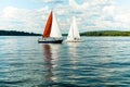 Berlin,Germany, 03.08.2019 .two beautiful sailing yachts on a blue lake and a green shore in the distance on a sunny day under a b Royalty Free Stock Photo