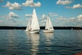 Berlin,Germany, 03.08.2019 .two beautiful sailing yachts on a blue lake and a green shore in the distance on a sunny day under a b Royalty Free Stock Photo