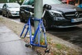 Berlin, October 2, 2017: Blue bicycle attached to street pillar with lock stands without wheels after being stolen in Royalty Free Stock Photo