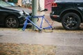 Berlin, October 2, 2017: Blue bicycle attached to street pillar with lock stands without wheels after being stolen in Royalty Free Stock Photo