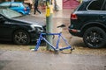 Berlin, October 2, 2017: Blue bicycle attached to street pillar with lock stands without wheels after being stolen in Royalty Free Stock Photo