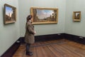 BERLIN - OCTOBER 20, 2016: Girl admiring paintings in famous Alt