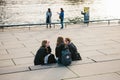 Berlin, October 3, 2017: A group of young girls friends of students sitting on the waterfront which is located near the