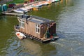 Berlin-Treptow, Germany - May 21, 2022, Floating wooden house. View of the Spree with restaurants and several boat