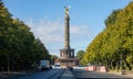 Berlin Victory Column. Golden statue of angel tries to touch the sky. Clouds, trees background