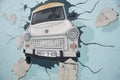 Berlin, the Wall, Painting, East Side Gallery. Old Trabant car breaks through the Wall Royalty Free Stock Photo