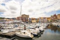 Bermeo, Basque Country, Spain - July 16, 2020: fishing port with colorful facades of houses and fishing boats against