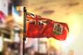 Bermuda Flag Against City Blurred Background At Sunrise Backlight