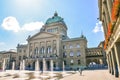 Bern, Switzerland - August 14, 2019: Building of the Swiss Parliament photographed from outside with people walking on the