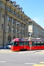 Bern, Switzerland - August 14 2019: Red tram in the city center of the Swiss capital. Red light on zebra crossing, city crossroad