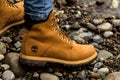 Bern, Switzerland,9.12.18: Almost ready. Close up of stylish yellow boot on female leg. Lady standing on the grass Royalty Free Stock Photo