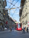Berne, Switzerland - April 16th 2022: A tramcar moving along historic buildings in the city centre.