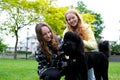 Bernedodle two teenage girls stroking a dog hugging playing with a pet sister friend Girlfriends classmates walking an Royalty Free Stock Photo