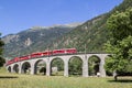 Bernina Express train is going through the famous circular viaduct