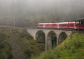 Bernina express train in the Swiss alps lost in the fog Royalty Free Stock Photo