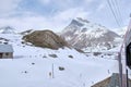 Bernina mountain pass. The famous red train is crossing the white lake. Amazing landscape of the Switzerland land. Famous