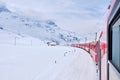 Bernina mountain pass. The famous red train is crossing the white lake. Amazing landscape of the Switzerland land. Famous