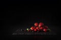 Berries assorted fresh mix colorful arrangement in studio on dark stone plate background Royalty Free Stock Photo