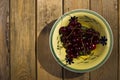 Berries cherry, behind the plate, standing on a wooden background. Royalty Free Stock Photo