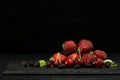 Berries closeup assorted fresh mix colorful arrangement in studio on dark stone background Royalty Free Stock Photo