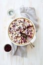 Berries, cream and almond homemade pie in white cooking tray