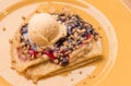 Berries Crumbles Cream Cheese Crepes on top with Vanilla Ice Cream.