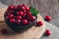 Berries are dogwood in a bowl on a wooden table, selective focus. Royalty Free Stock Photo