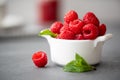 Berries of fresh large raspberries in a white bowl Royalty Free Stock Photo