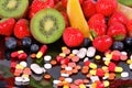 Berries, fruits, vitamins and nutritional supplements Royalty Free Stock Photo