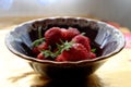 Berries of homegrown strawberries in a ceramic bowl
